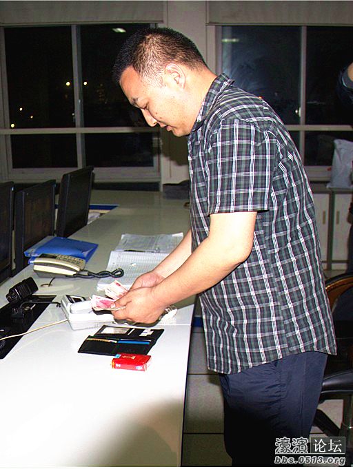 图为樊斌在清点钱包的镜头