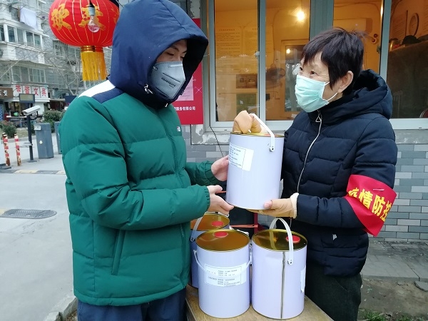 志愿者为社区送来消毒用品.jpg
